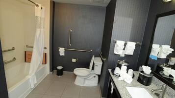A modern bathroom with a bathtub, toilet, and sink.