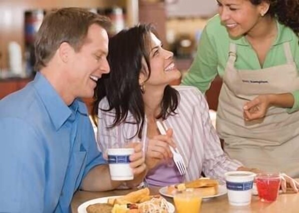 A dining table with food and drinks. - Hampton Inn & Suites Albany At Albany Mall (Albany)