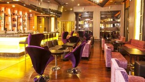 A bar area with purple chairs and a bar counter. - Widus Hotel Clark (Mabalacat City)