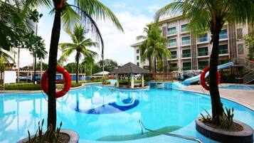 Swimmers can enjoy the pool surrounded by palm trees and safety lifebuys.