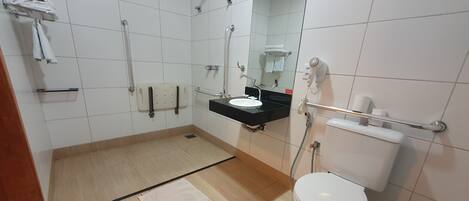 A modern bathroom with a shower, toilet, and sink.