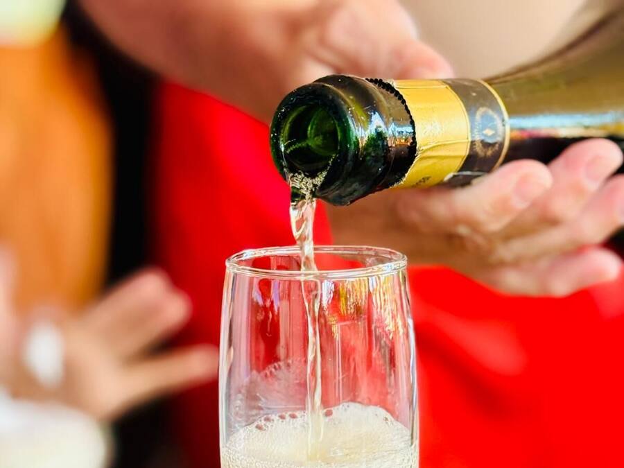 A person pouring champagne into a glass.