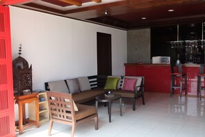 Relax in this stylish living area with a sofa set, coffee table, and comfortable chair.