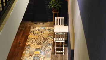 A staircase with a patterned floor leading to a landing.