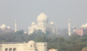 The Taj Mahal with its iconic domes and minarets, surrounded by greenery. - Hotel Mumtaz Mahal (Agra)