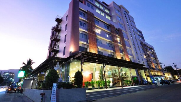 A multi-story hotel with a modern design, featuring a covered entrance and a visible staircase leading to the upper floors. - Mayflower Grande Hotel Chiang Mai (Chiang Mai)