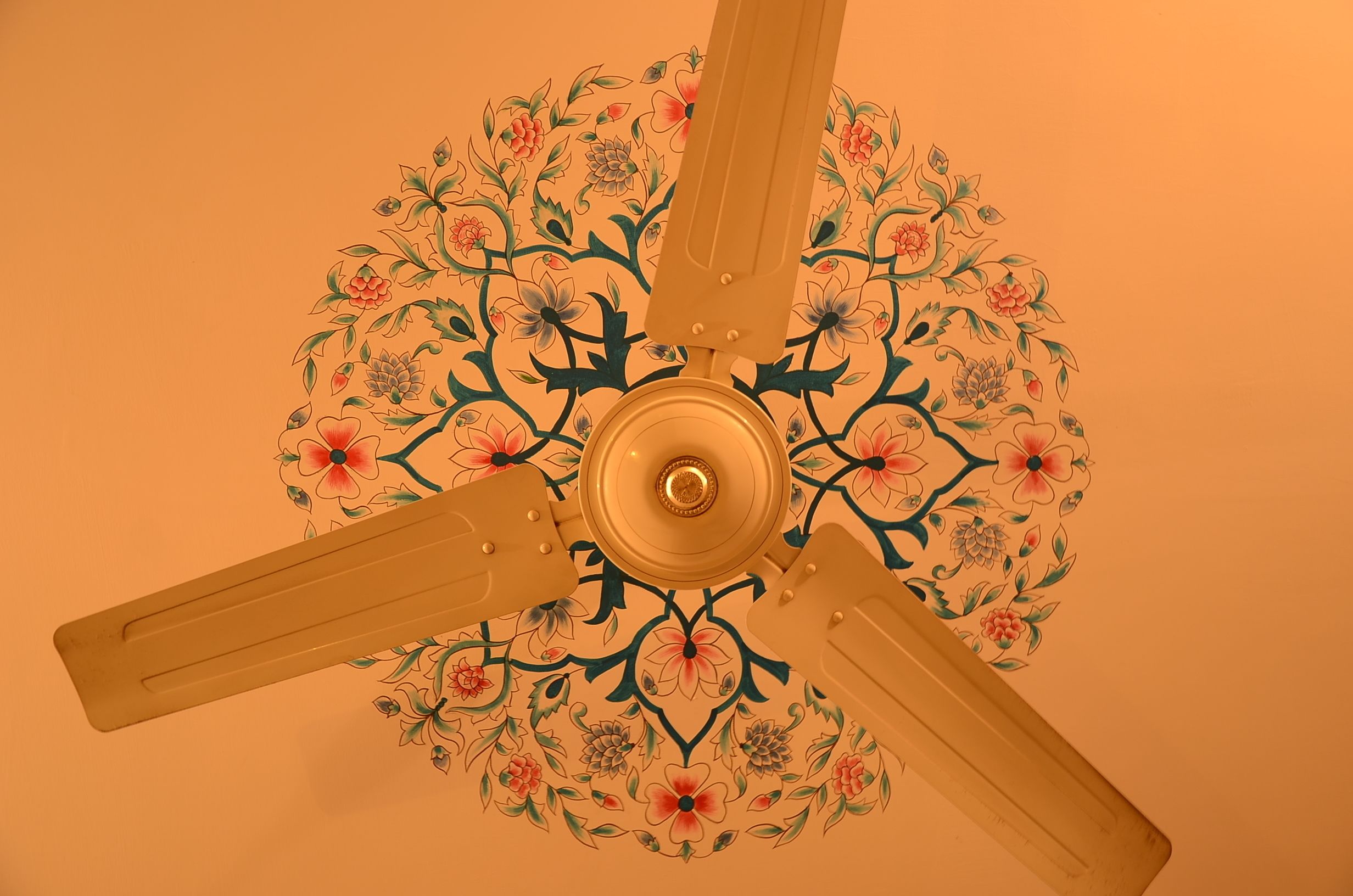 A ceiling fan with a floral design.