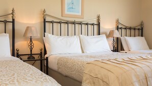 A hotel room with two beds, each with a headboard and bedside tables. - Fern Rock B&B (Milltown)