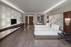 A hotel room with a large bed, a TV, a minibar, and a bathroom visible through an open door. - DoubleTree By Hilton Istanbul Gayrettepe (Istanbul)