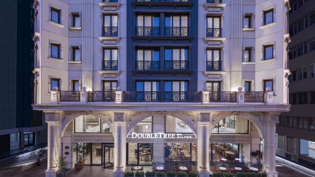 A hotel with a classical facade, multiple balconies, and a central entrance with a sign reading "DOUBLETREE MILTON". - DoubleTree By Hilton Istanbul Gayrettepe (Istanbul)