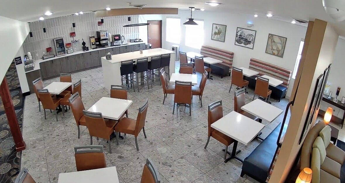 A restaurant with multiple dining areas, a counter, and a bar.