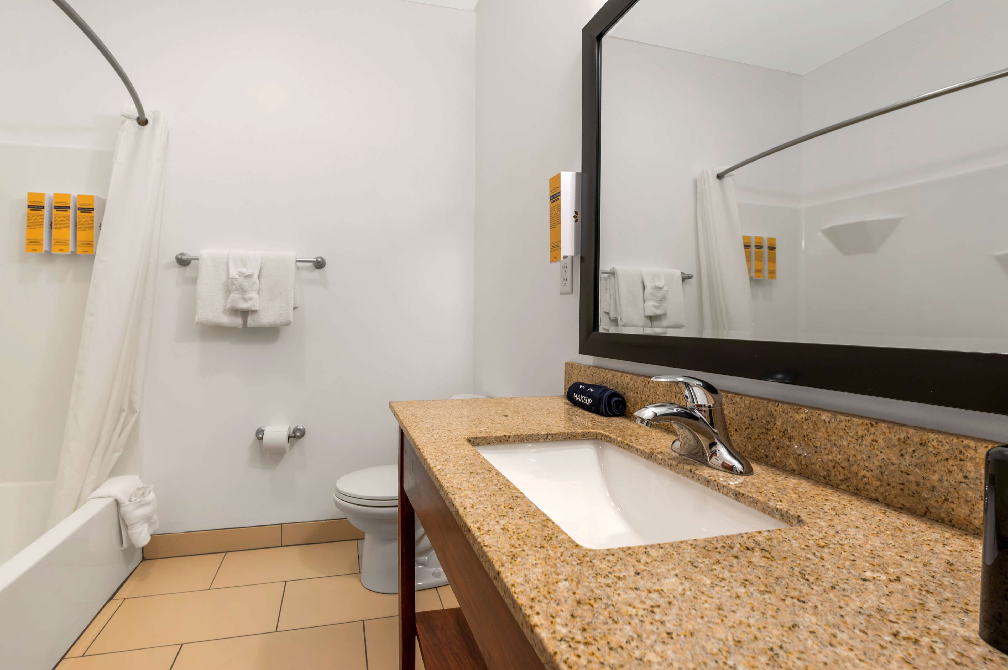 standard room, 2 queen beds, non smoking, refrigerator & microwave | bathroom | combined shower/bathtub, designer toiletries, hair dryer, towels