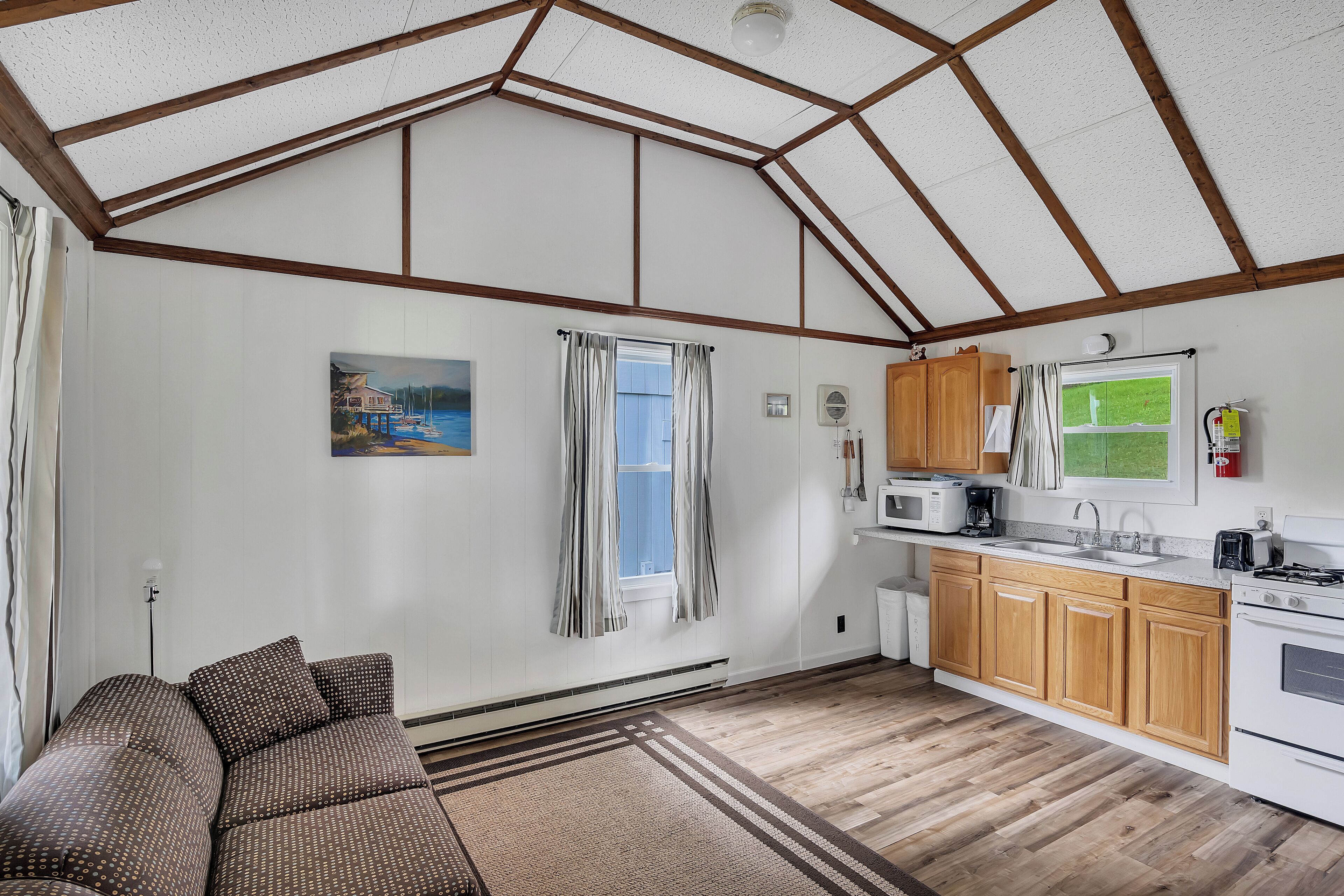 A spacious kitchen with wooden cabinets, a microwave, and a stove.