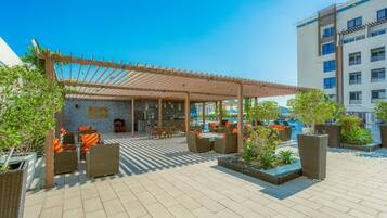 Outdoor pool, open 6:00 AM to 10:00 PM, pool umbrellas, pool loungers