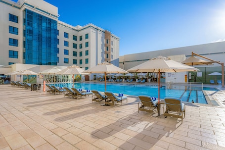 Outdoor pool, open 6:00 AM to 10:00 PM, pool umbrellas, sun loungers