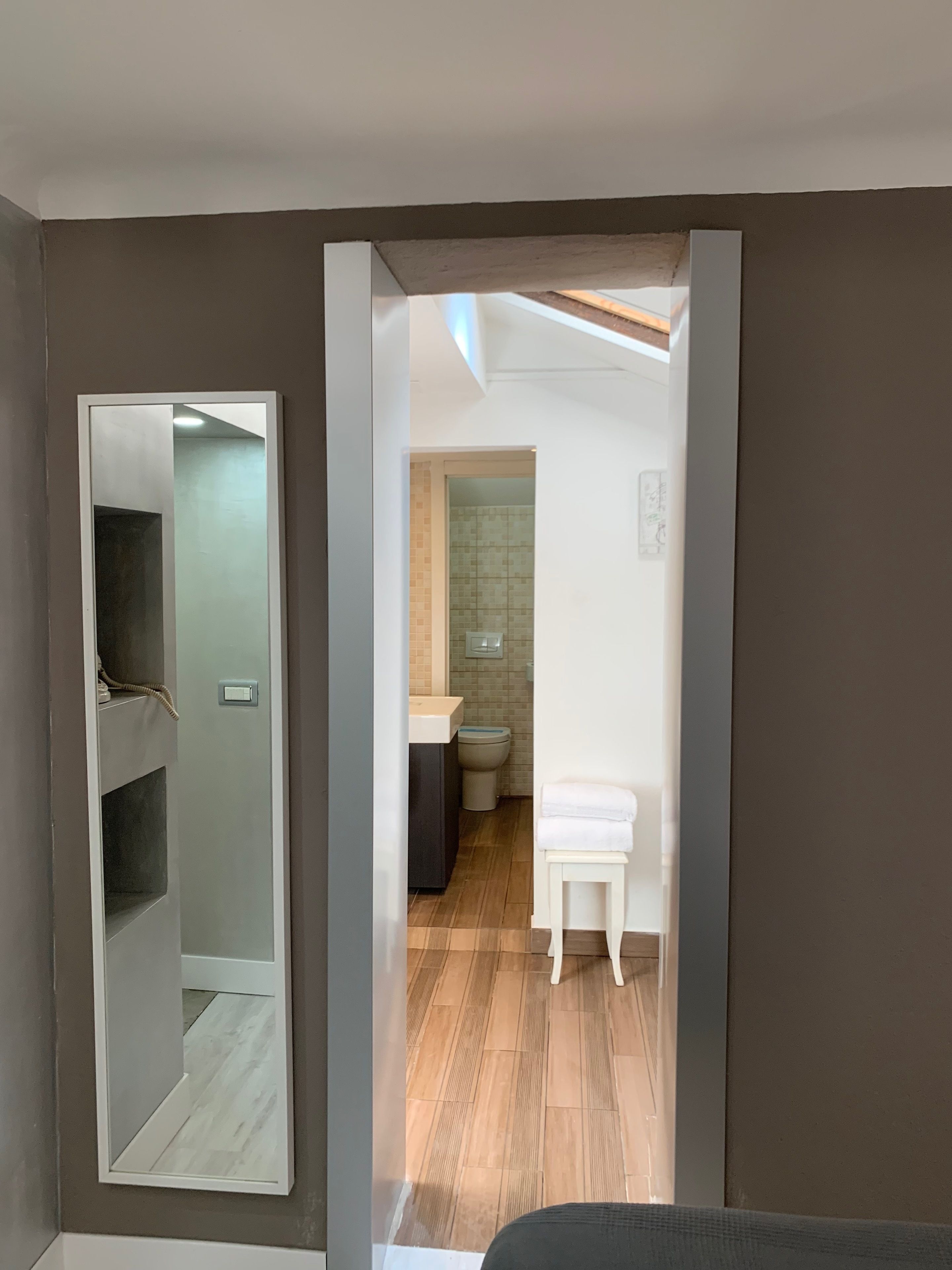 A modern bathroom with a shower, toilet, and sink.