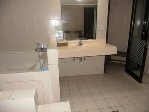 A bathroom with a bathtub, a sink, and a shower.