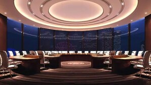A modern conference room with a circular ceiling design, multiple screens, and a central table. - Mövenpick Enshi (Enshi)