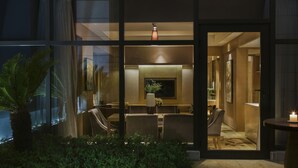 A modern hotel lobby with a seating area, a TV, and a large window. - Mövenpick Enshi (Enshi)