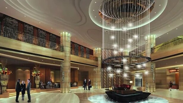 A spacious lobby with a central fountain, high ceilings, and modern lighting. - Mövenpick Enshi (Enshi)