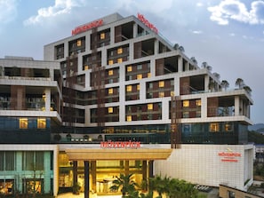A multi-story hotel with a prominent 'MÖVENPICK' sign, large windows, and a modern architectural design. - Mövenpick Enshi (Enshi)