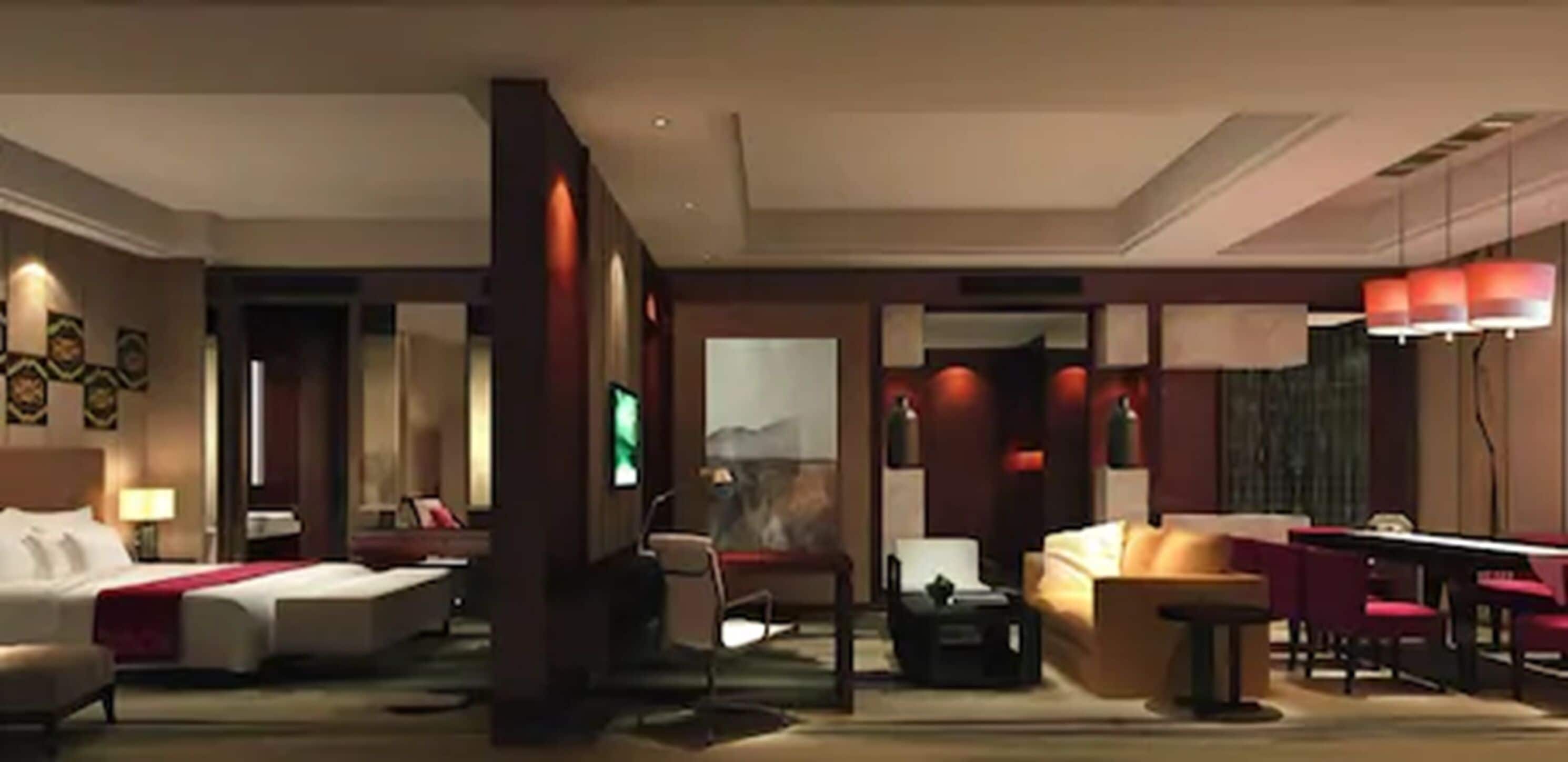 Une chambre d’hôtel équipée d’un lit, d’un bureau, d’une chaise, d’un canapé et d’une table de billard.