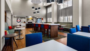 A modern hotel lobby with a bar area, seating arrangements, and a view of the outside. - Hampton Inn & Suites Schererville (Schererville)