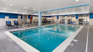 An indoor swimming pool with a blue and white color scheme, a lounge area with chairs and tables, and a 'Poor Lift' sign indicating accessibility features. - Hampton Inn & Suites Schererville (Schererville)