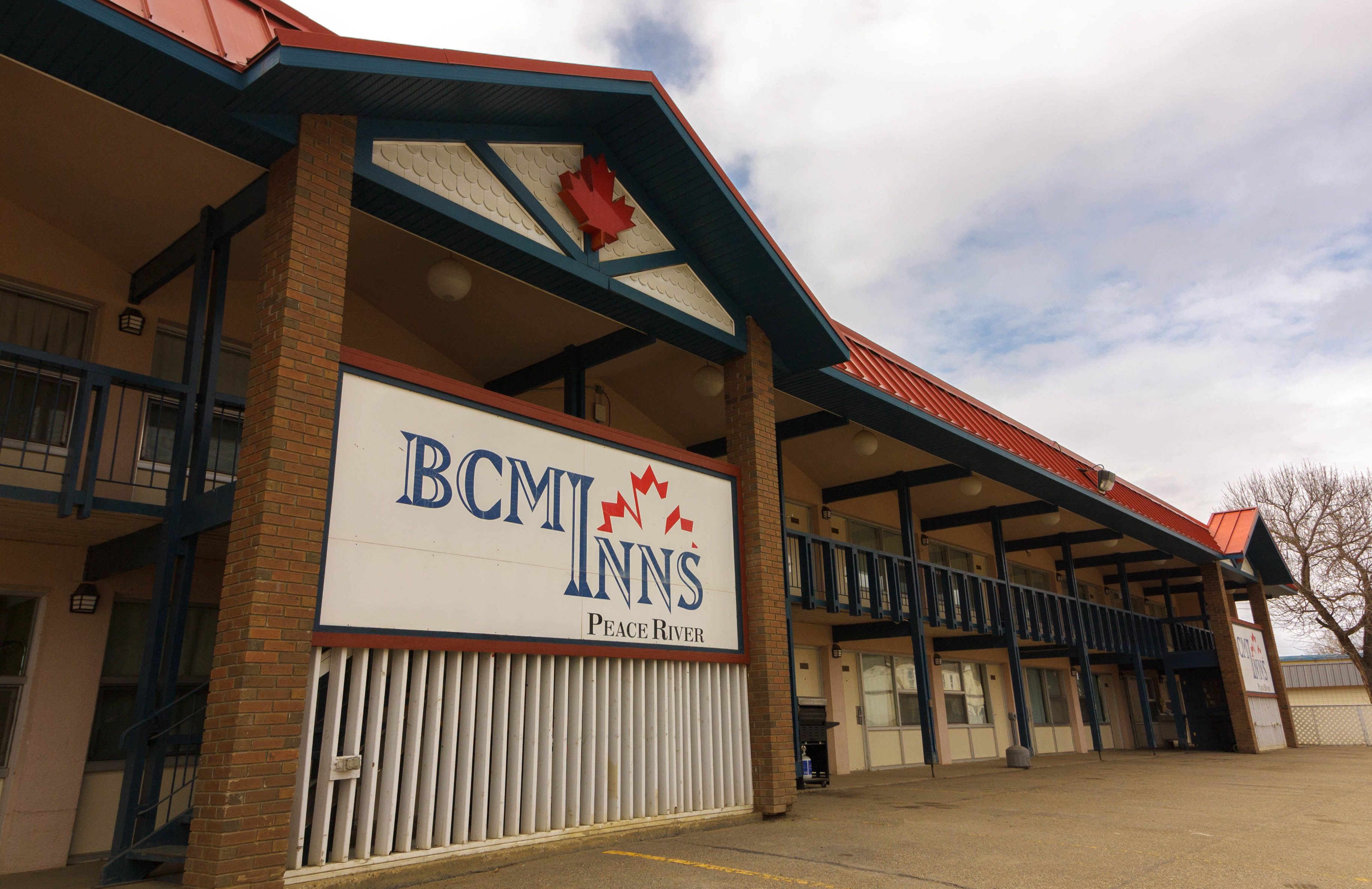 A hotel with a prominent sign reading "BCM INN'S Peace River."
