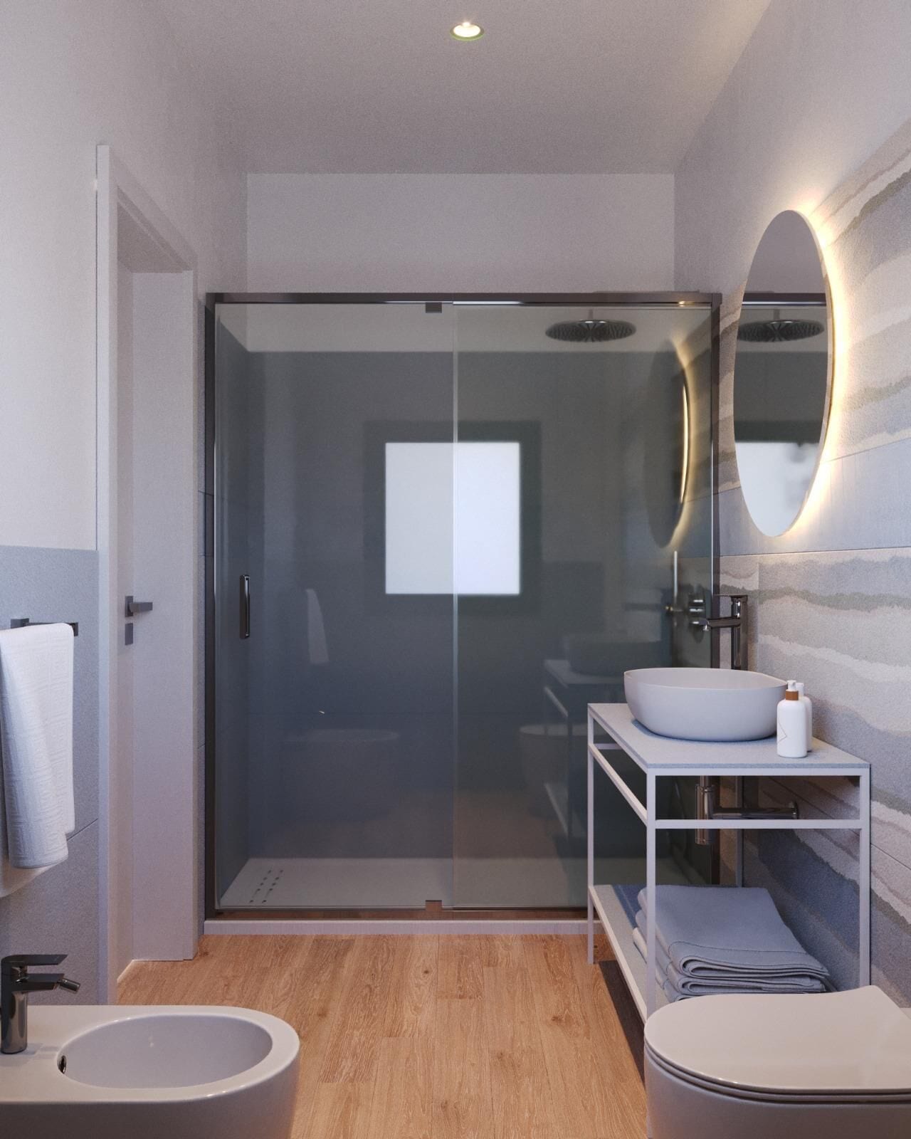 A modern bathroom with a glass shower enclosure, a round sink, a toilet, and a vanity with a mirror.