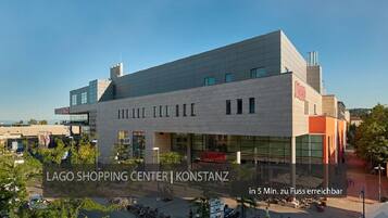 A modern shopping center with a prominent 'LAGO' sign.