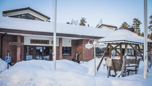 A brick building with a sign reading "Vuolake" and a wheelchair accessibility sign. - Hotelli Vuolake (Laukaa)