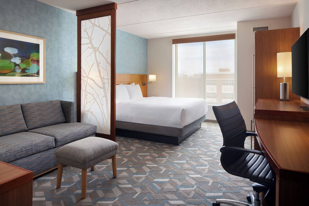 Premium bedding, desk, laptop workspace, blackout curtains