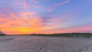 A beach with a sunset. - Granada Ocean Resort (Wildwood Crest)