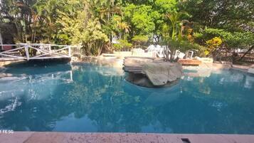Outdoor pool, open 7 AM to 10 PM, pool loungers