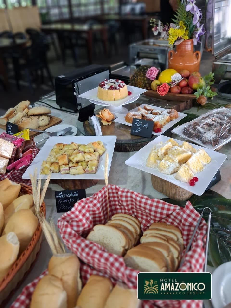 A variety of baked goods and pastries displayed on a table in a restaurant setting.