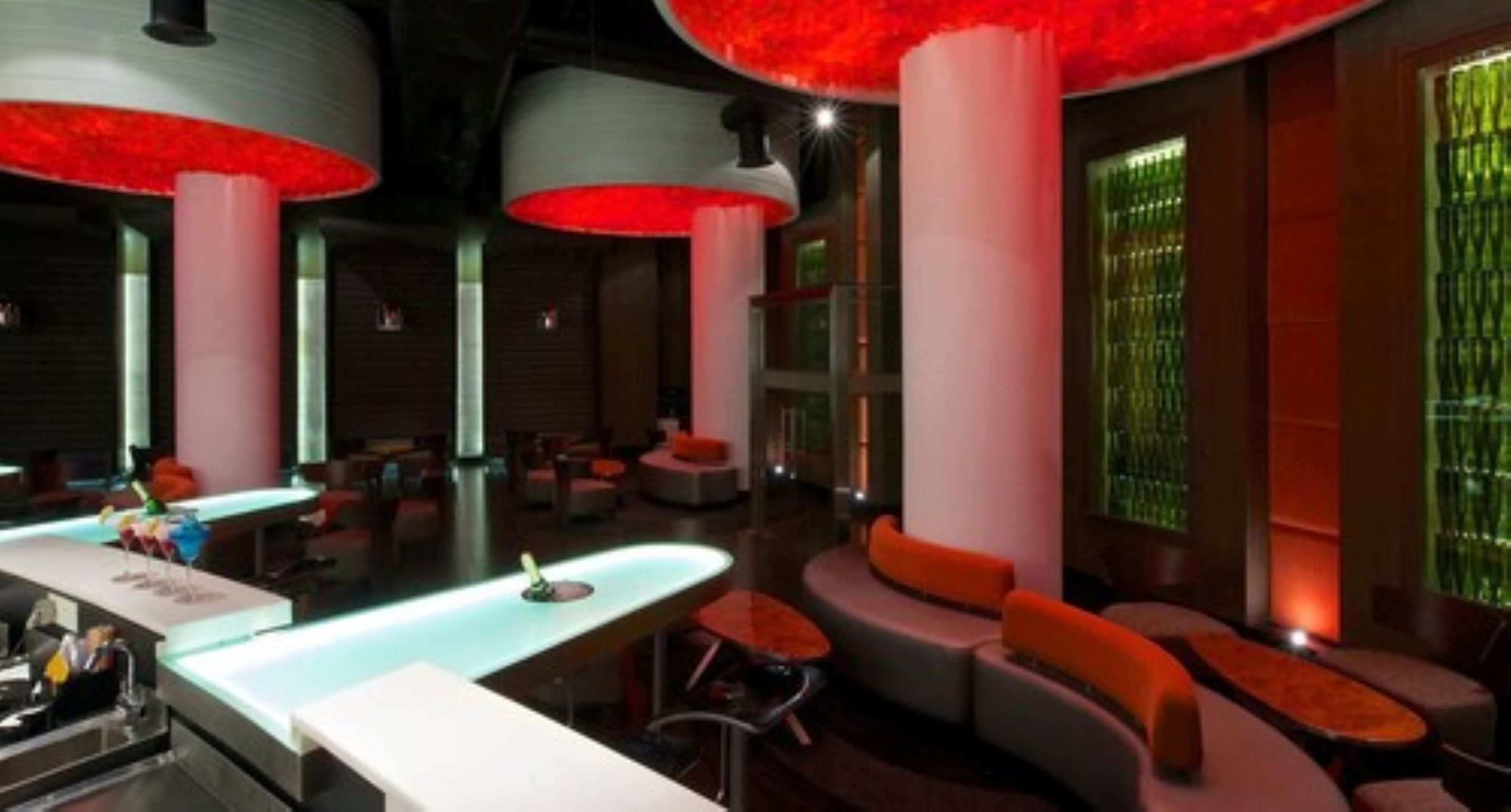 A modern lounge area with seating and a bar.