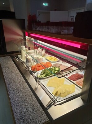 A buffet with various food items including sliced vegetables, meats, and cheeses. - Aurora Hotel at Reykjavik-Keflavik Airport Terminal KEF (Suðurnesjabær)