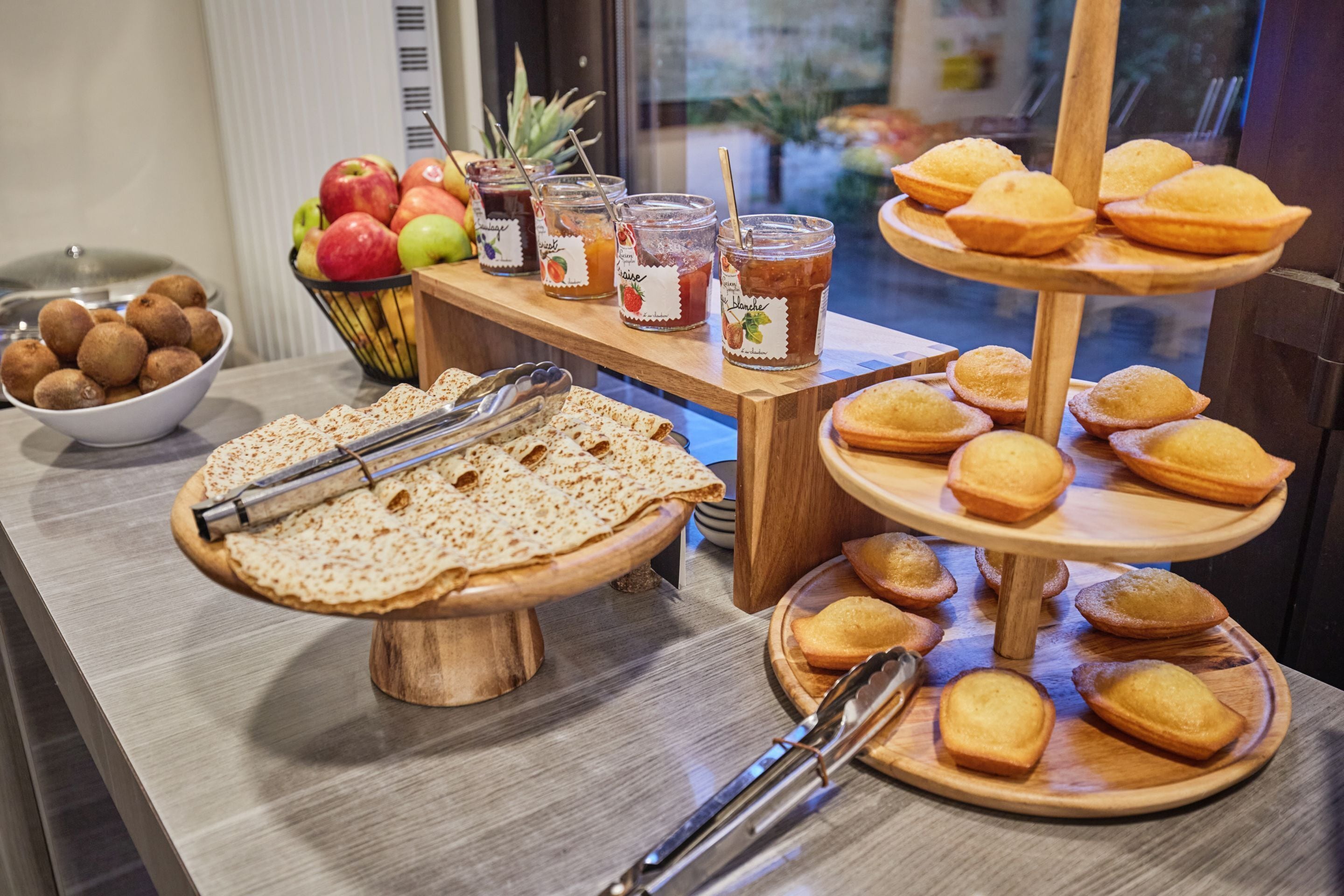 A breakfast buffet with various food items and drinks.