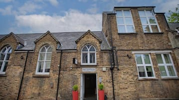 A reception area with a brick facade, arched windows, and a door labeled 'RECEPTION'.