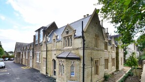 A historic building with a traditional architectural style, featuring multiple windows and a pitched roof. - Arch hotel (London)