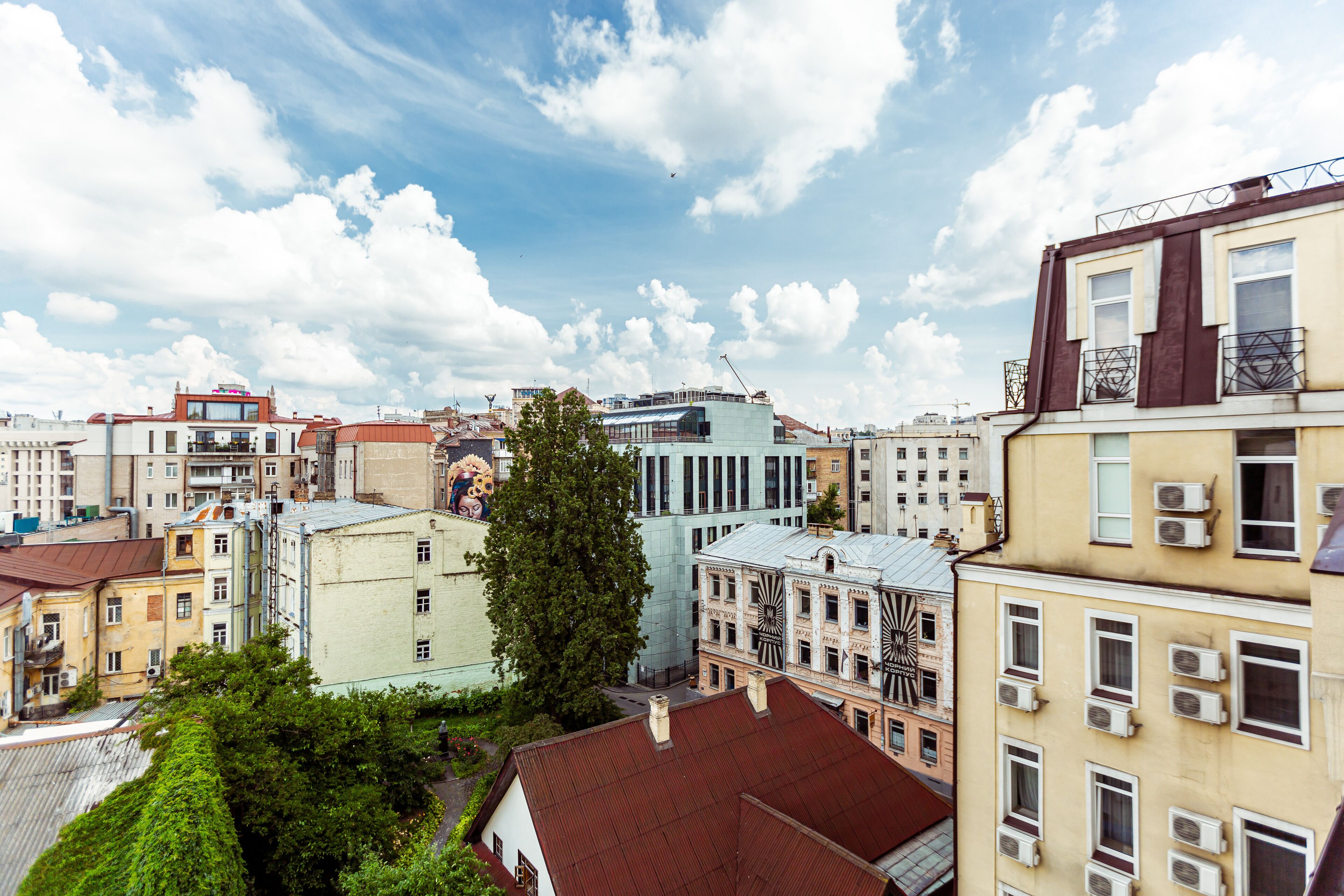 A cityscape with various buildings, including a prominent building with a large clock tower.