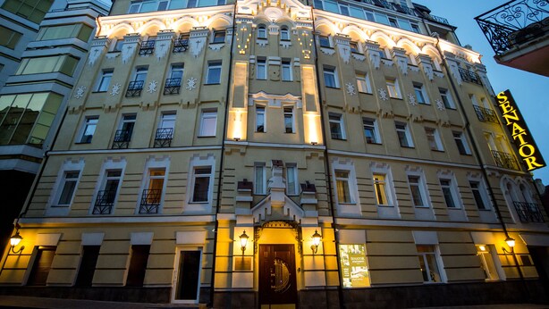 A historic building with ornate architecture, multiple balconies, and a prominent entrance with a decorative door. - Senator Maidan (Kyiv)