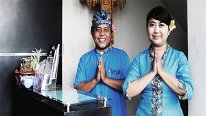 A room with a black cabinet, a small table, and a decorative item on the cabinet. - Taman Tirta Ayu (Tuban)