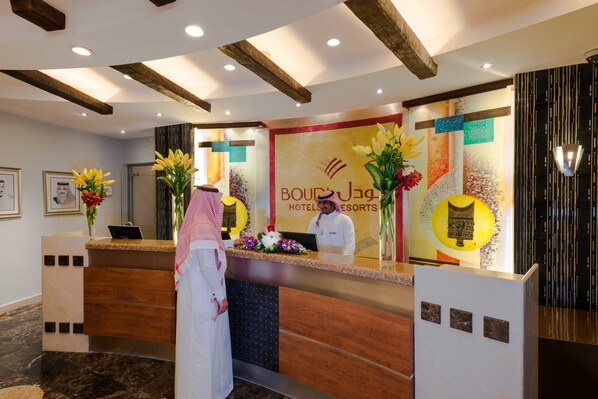 Welcome to the Boujaga Hotel & Resorts, where a beautiful mural and elegant reception desk set the tone for a memorable stay.