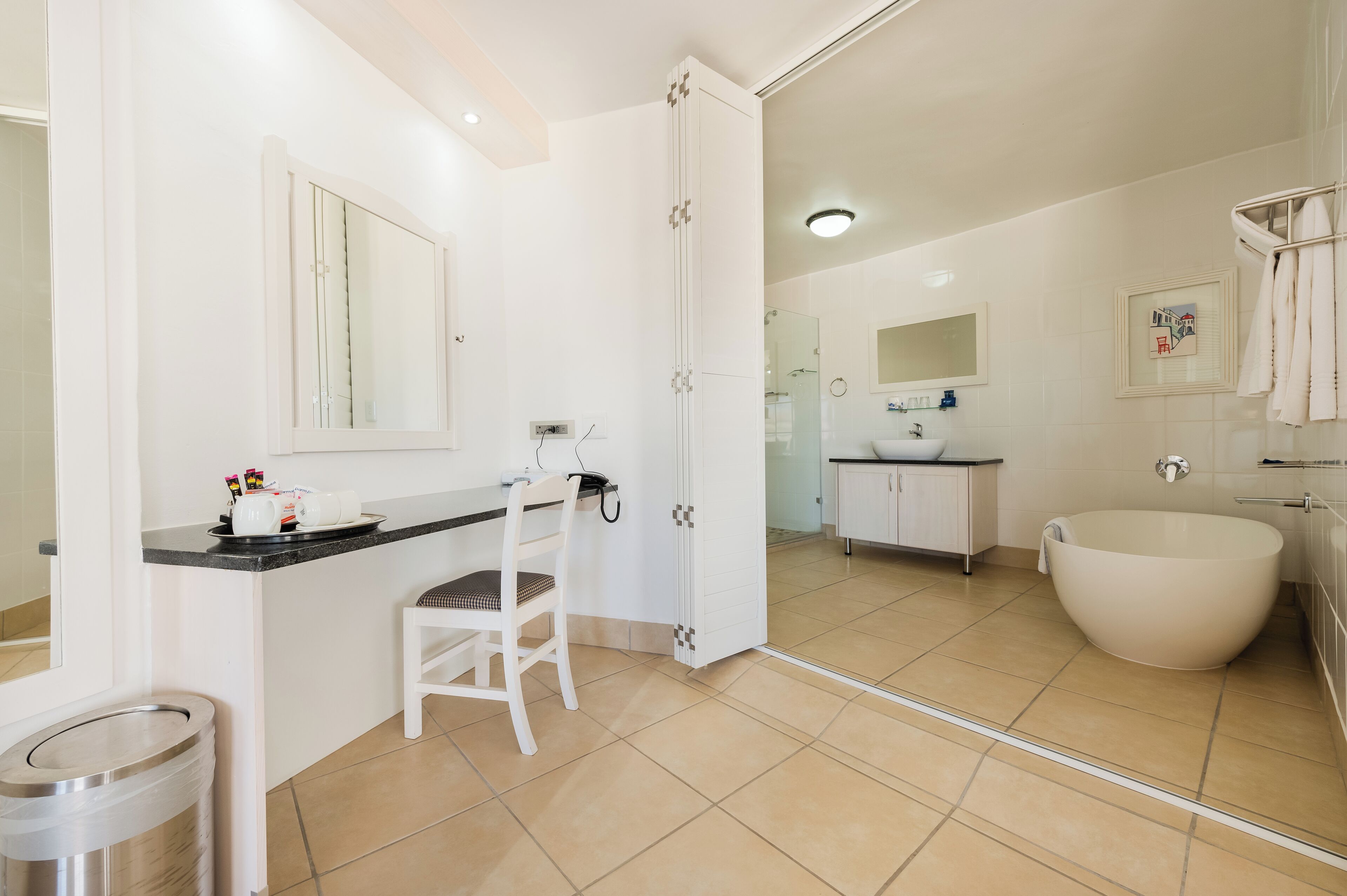 Une salle de bain moderne avec une grande baignoire, un lavabo et un miroir.