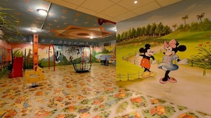A children's play area with colorful murals and a play structure. - Boudl Al Shatea (Dammam)