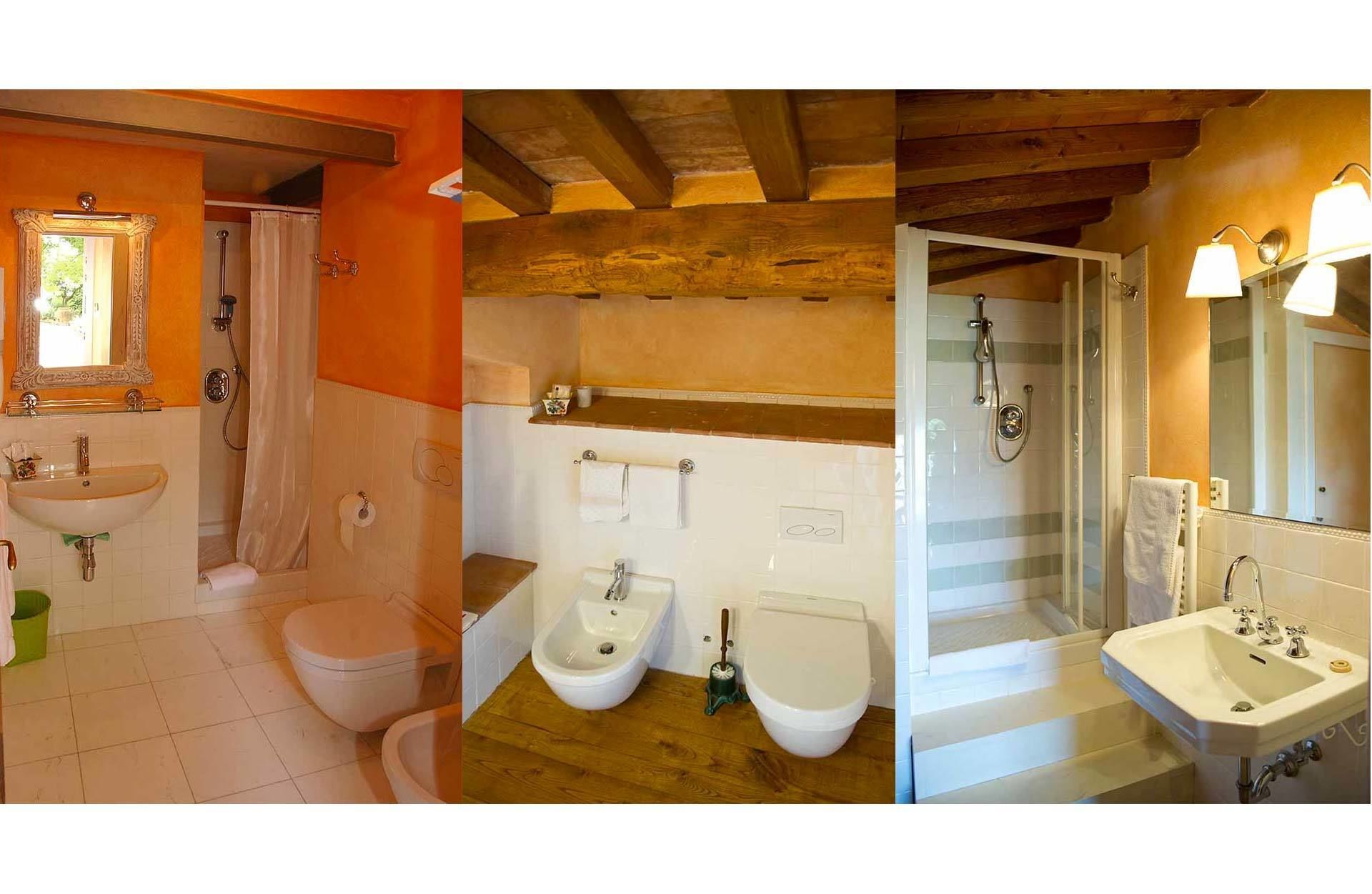 A bathroom with a sink, toilet, bidet, and shower.