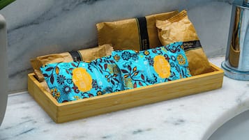 A wooden box with colorful packaging on a marble surface.