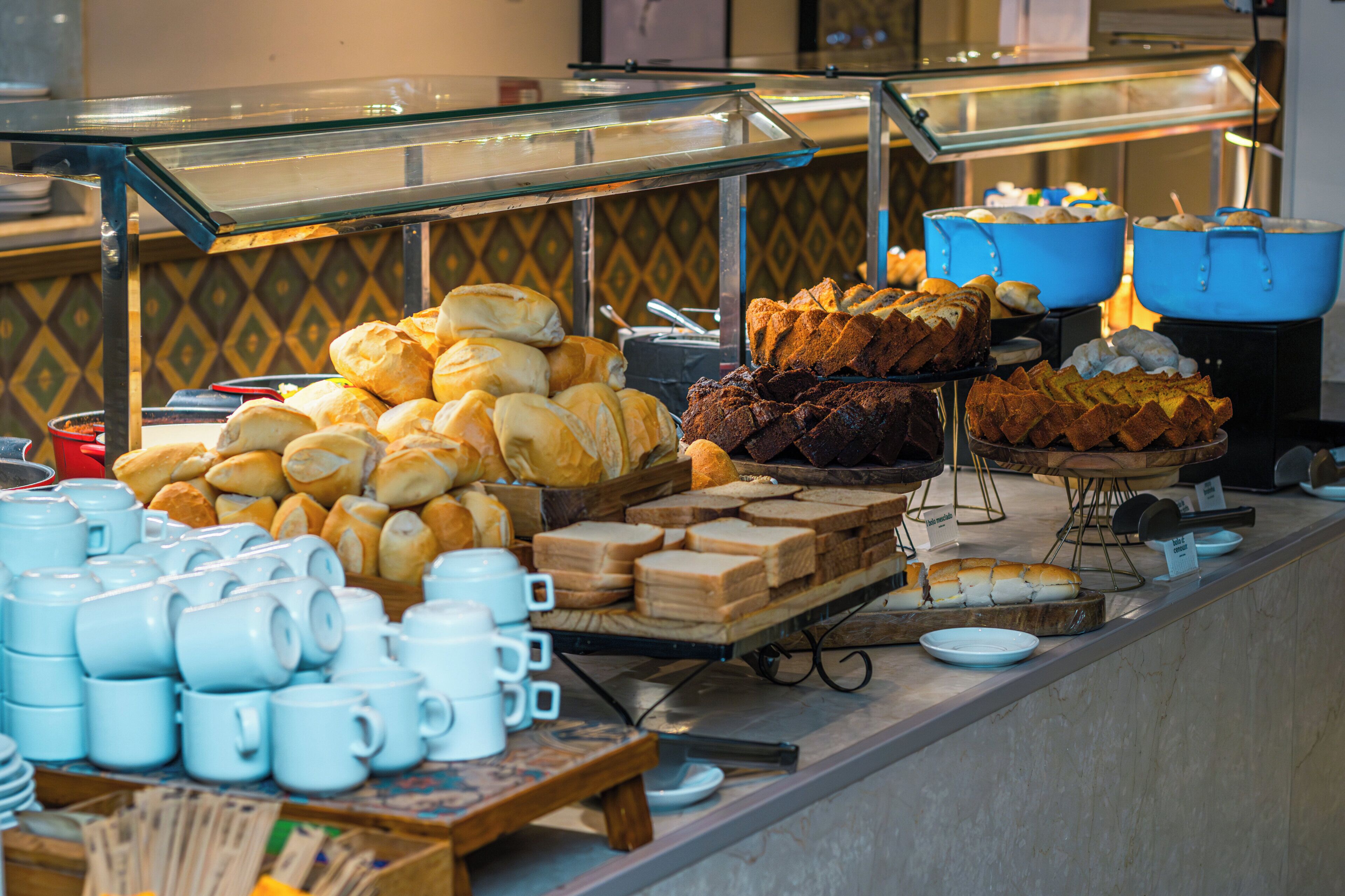 A buffet with various food items and utensils.